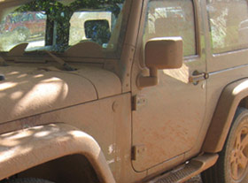 Mud covered Jeep Wrangler rental